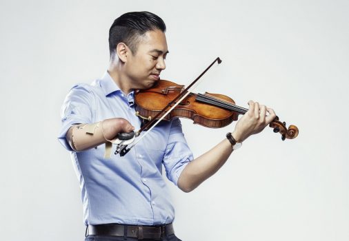 Promotional photo: Adrian Anantawan in light blue shirt, plays violin.