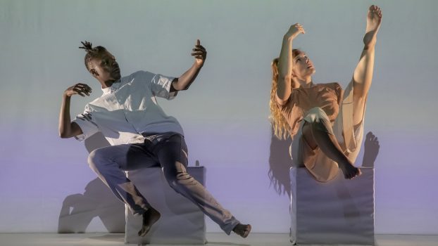 宣傳照：兩位舞者坐在白色箱子上，身體擺出如漂浮於無重狀態的動作。