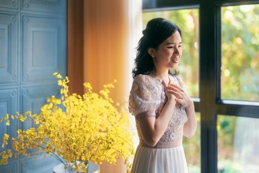 Promotional photo: Michelle Siu is singing next to the windows in a bright room